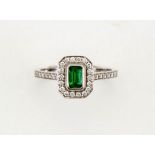 An 18ct white gold, emerald and diamond Art Deco style ring, size N½, 3.7g.