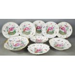 A group of 19th century Chelsea plates, dishes and bowls, depicting peacocks, butterflies and
