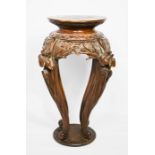 A Chinese hardwood jardiniere stand, carved with protruding flowers to the top of the legs. Height