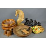 A group of treen to include bowls, carved horse, and carved African group of elephants and other