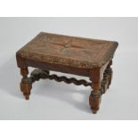 A small 19th century oak stool, with lunette carved edge and flowerhead to the centre, raised on