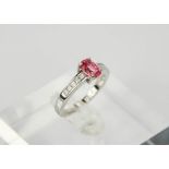 An 18ct white gold and oval pink spinel ring, approx 0.80ct, with princess cut diamonds to the