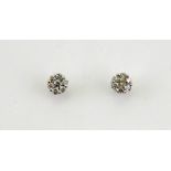 A pair of 18ct white gold diamond cluster earrings, the diamonds totalling approx 1ct.