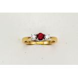 An 18ct yellow gold three stone diamond and garnet trilogy ring, size M, 3.4g.