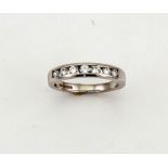 An 18ct white gold and diamond eternity ring, set with seven brilliant cut diamonds totalling 0.