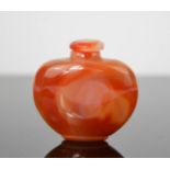 A Chinese red agate handcarved snuff bottle