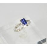An 18ct white gold, diamond and sapphire ring, with emerald cut sapphire approx 0,70ct, and diamonds