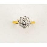An 18ct yellow gold daisy rubover diamond cluster ring size N, 3.7g.