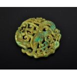 A Chinese natural green jade hand carved pierce-work dragon pendant. 6.5cm by 6.5cm