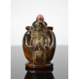 A Chinese handcarved cattle bone figural snuff bottle, with jade stopper and original copper spoon .