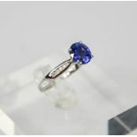 An 18ct white gold, sapphire and diamond ring, the sapphire approx 1.5ct, diamonds set to the