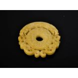 A Chinese natural pale yellow jade hand carved dragon pendant. 7.5cm wide