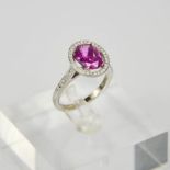 An 18ct white gold, pink sapphire and diamond ring, the sapphire approx 2.7cts surrounded by 0.
