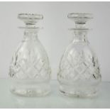 A pair of cut glass decanters, 21cm high.