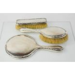 A silver dressing table set, comprising hand mirror, hair brush, and clothes brush, Birmingham,