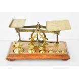A set of Victorian oak and brass Postal letter scales, with the original weights, the oak base
