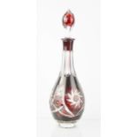 A red Bohemian cut glass decanter, 37cm high.