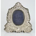 A silver photograph frame, embossed with scrollwork, 22 by 20cm.