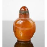 A early 20th century brown agate hand carved snuff bottle with copper spoon and collar