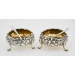 A pair of silver salts, embossed with floral decoration, residual gilded interior, London 1901,