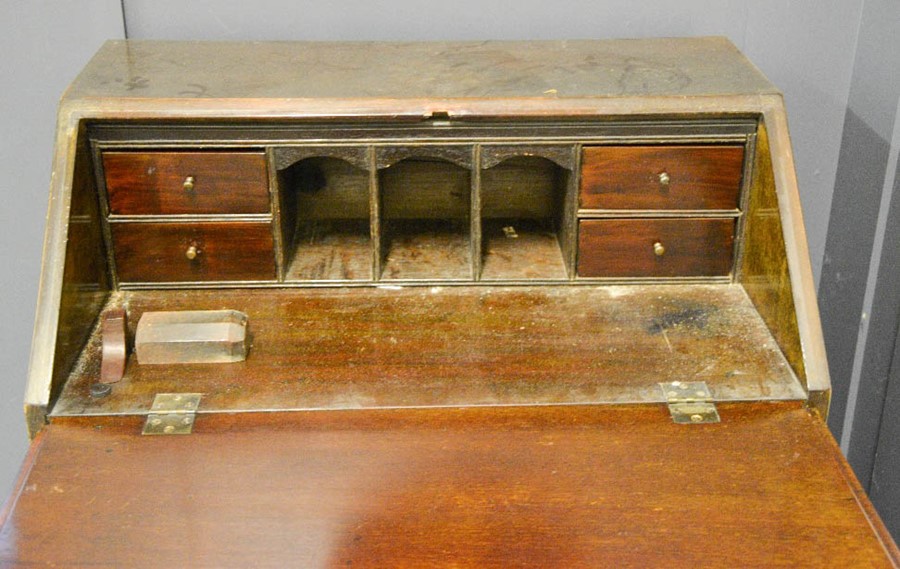 A small 19th century mahogany bureau, the fall front enclosing a fitted interior, above four long - Image 2 of 2