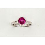 An 18ct white gold, pink sapphire and diamond trilogy ring, the brilliant cut sapphire approx 1ct,