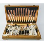 An oak cased silver plated canteen of cutlery.
