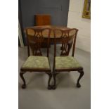 A set of four mahogany dining chairs, with pierced splats and upholstered drop in seats.