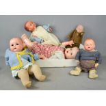 A group of four vintage dolls.