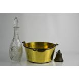 A Victorian brass jam pan together with an antique bell and a cut glass decanter.
