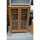 A pine glass fronted bookcase