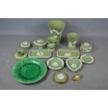 A quantity of Wedgwood green Jasperware to include vase, compact , pill box, trinket dish etc