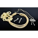 A group of jewellery to include three string simulated pearl necklace, paste / diamante necklace and