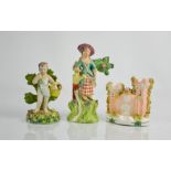 A 19th century Staffordshire pottery lady with watering can and bocage, signed Walton, a