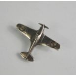 A silver brooch in the form of a War period plane.