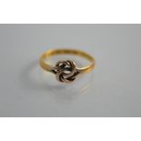 A 22ct gold knot ring size e/f 1.1g together with a red cross badge