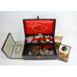 A jewellery box containing silver rings, brooches, amethyst pendants, necklaces, beaded bracelets,