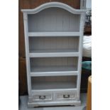 A painted pine shelving unit with two drawers