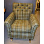 A modern tweed upholstered armchair with button back.