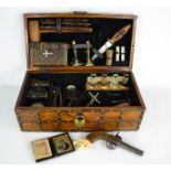 An early 20th century vampire hunting kit, the walnut studded case having a fitted interior