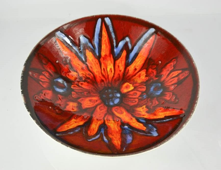 A Poole pottery bowl, with red ground, 34cm diameter.