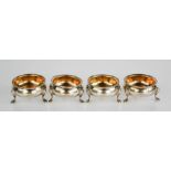 A set of four silver salts, with beaded edges and raised on three feet, residual gilt interiors,