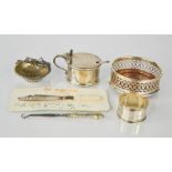 A group of silver to include napkin ring, salt with blue liner, coaster, and other items,