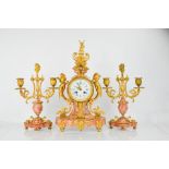 A 19th century French gilt metal and pink marble clock garniture, stamped H & F Paris, the clock