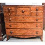 A Victorian mahogany chest of drawers, with central deep drawer flanked by two short drawers,