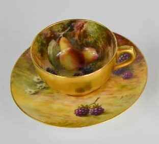 A Royal Worcester coffee can and saucer painted with fruits, signed Phillips, with gilded