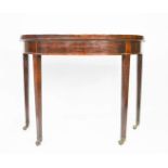 A 19th century mahogany demi lune card table, raised on square tapered legs and castors. Height