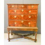 A George III walnut veneered chest on later stand, with two short over three long graduated drawers,