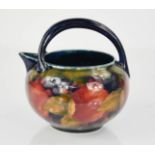 A Moorcroft jug in the pomegranate pattern, with impressed Burslem mark to the base and green