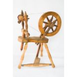 An antique pine spinning wheel, 93cm high.